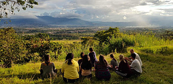 Students sit overlooking the mountains of Costa Rica during a faculty-led trip on sustainability ...