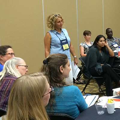 Dr. Aguanno (standing) leads a workshop at the Missouri conference.