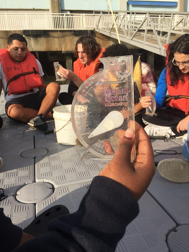NYC 103 freshmen test water quality at the River Project at Pier 40 on the Hudson River.