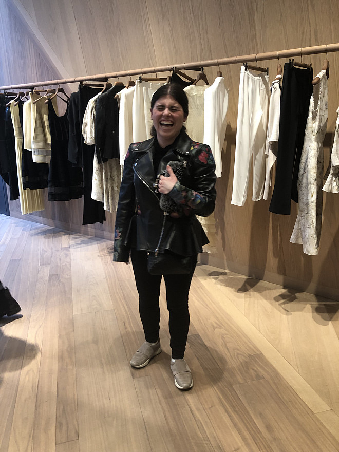 Olivia having fun trying on a jacket at the Alexander McQueen flagship store in London