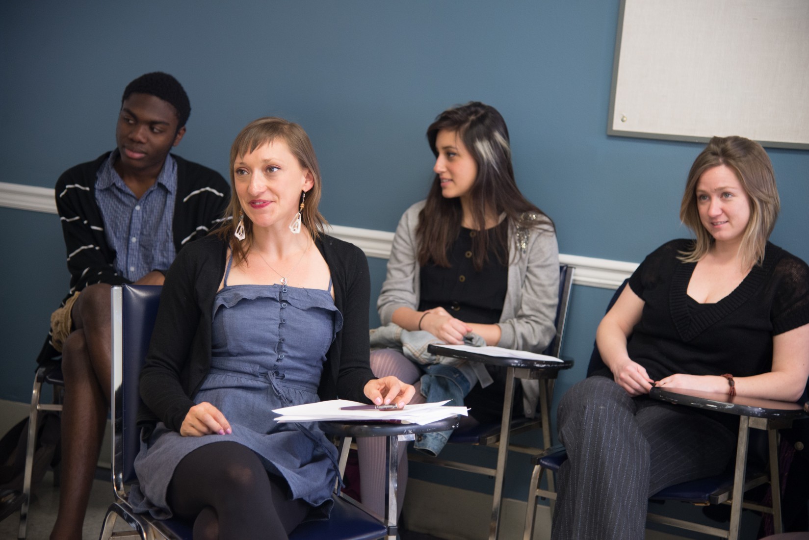 French professor Julie Huntington (foreground) and her students listen to a presentation