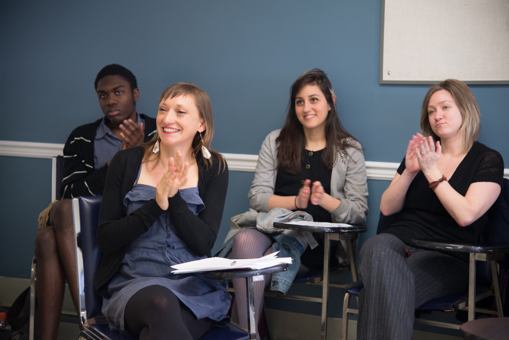 French professor Julie Huntington (foreground) and her students listen to a presentation