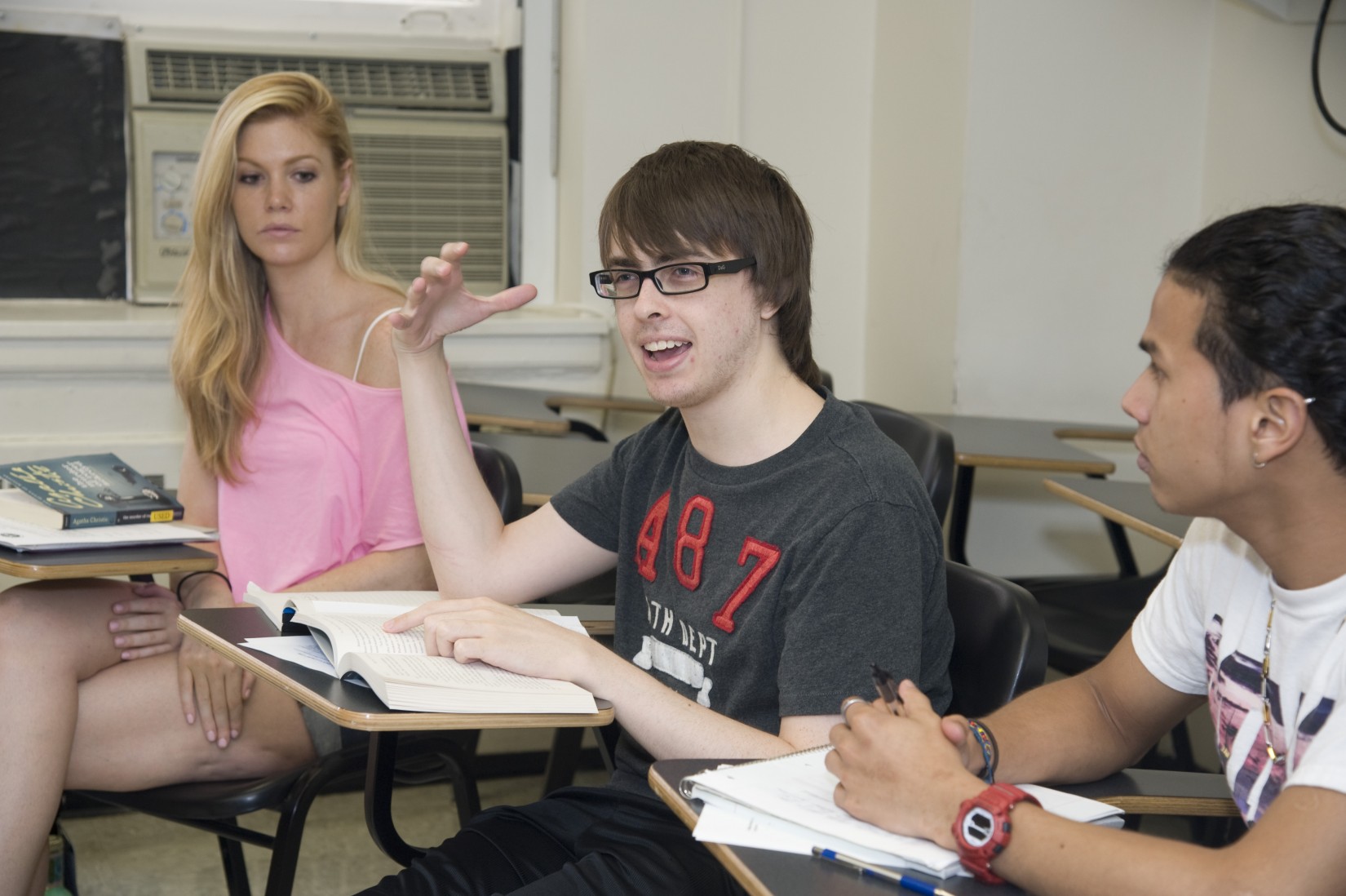 A student shares his perspective in Prof. Feilla's Detective Narratives summer course while classmates listen