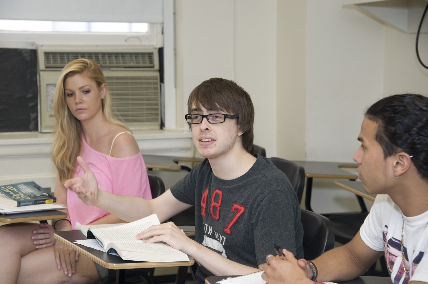 A student shares his perspective in Prof. Feilla's Detective Narratives summer course while classmates listen