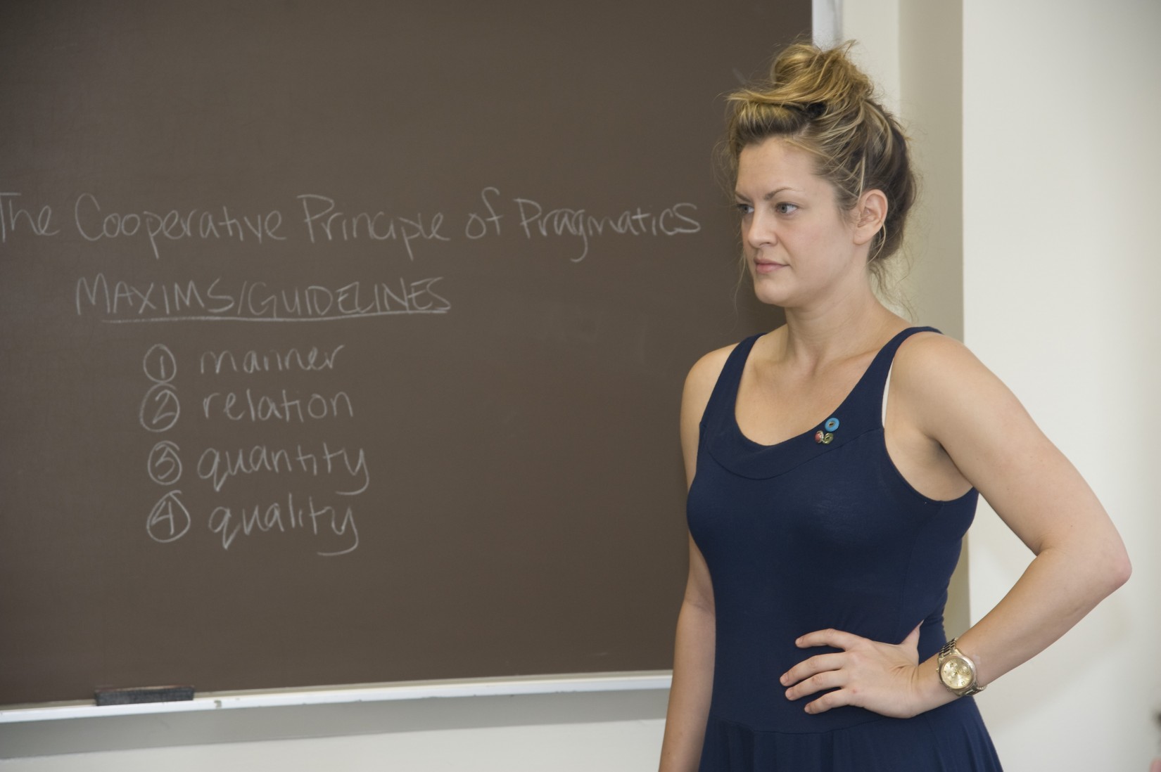 A student writes notes on the board in Prof. Feilla's Detective Narratives summer course