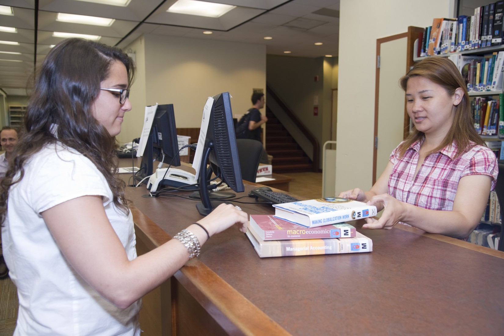 Checking out at the circulation desk in the Shanahan Library