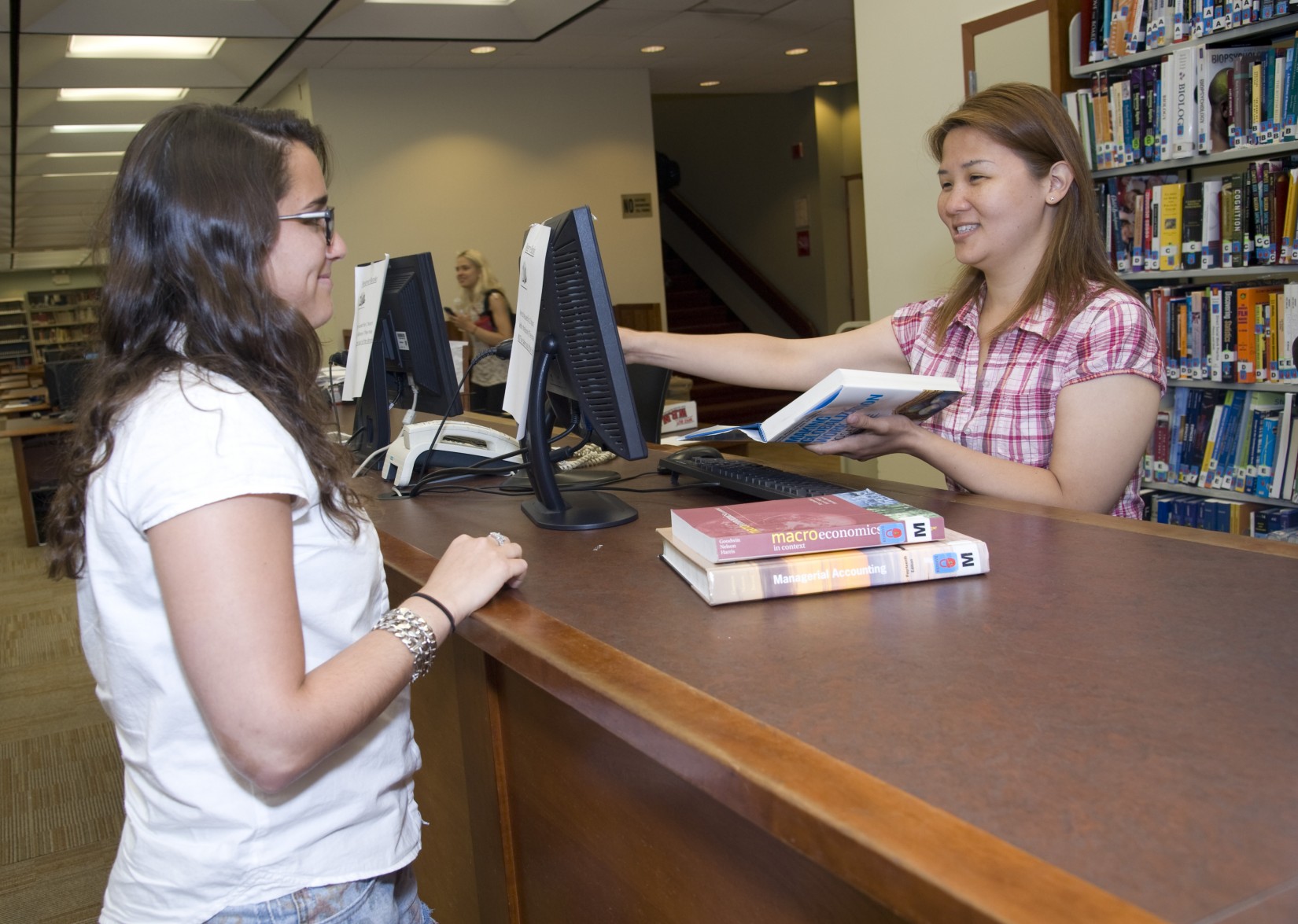 Checking out at the circulation desk in the Shanahan Library