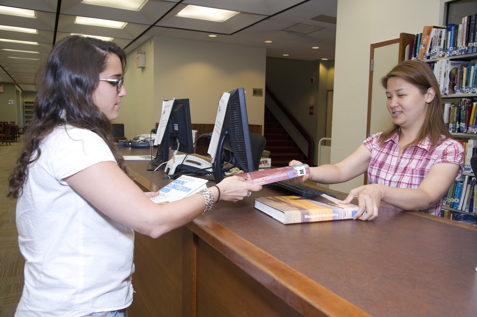 Checking out at the circulation desk in the Shanahan Library