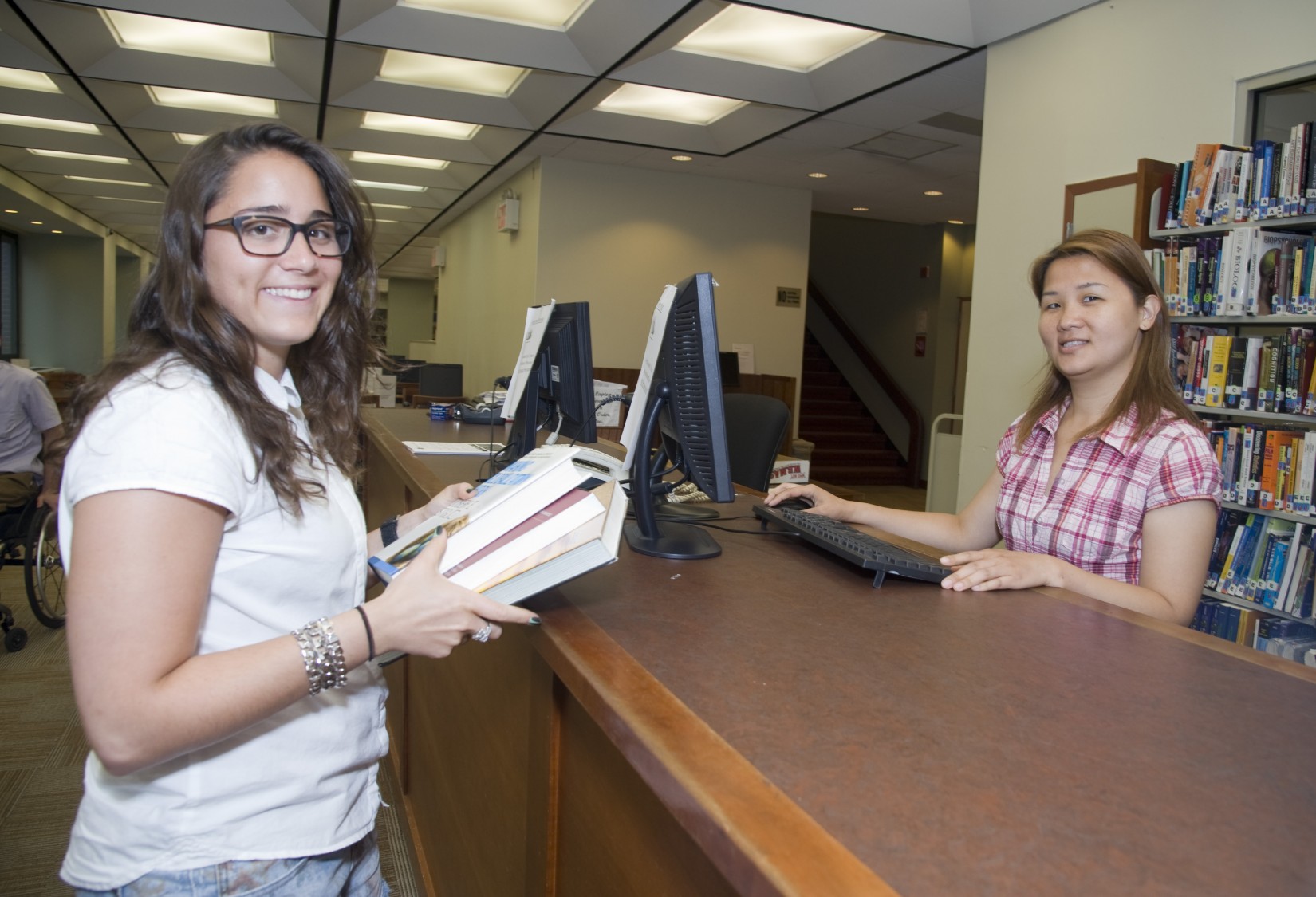 Checking out at the circulation desk in the Shanahan Library