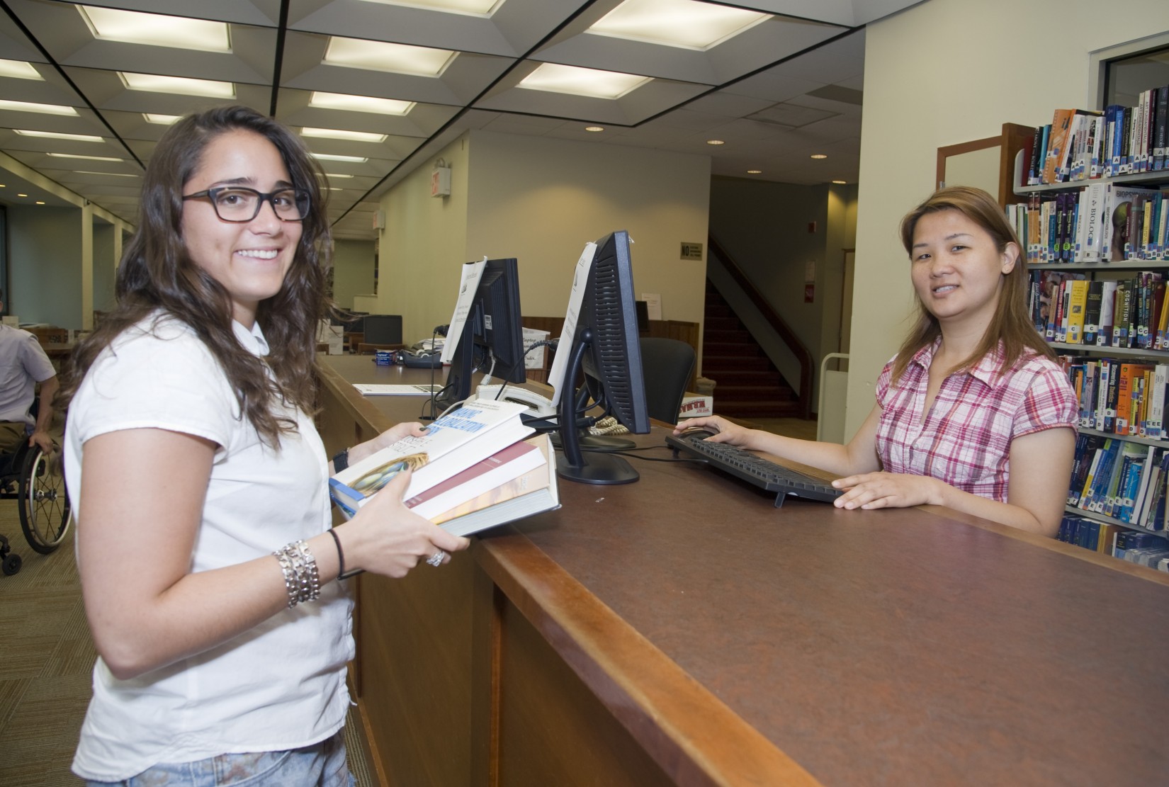 Checking out at the circulation desk in the Shanahan Library