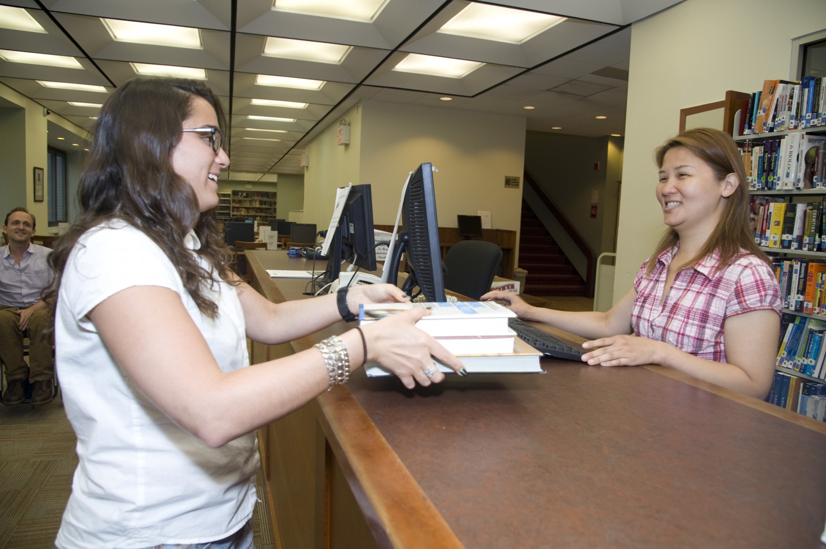 Checking out at the circulation desk in the Shanahan Library