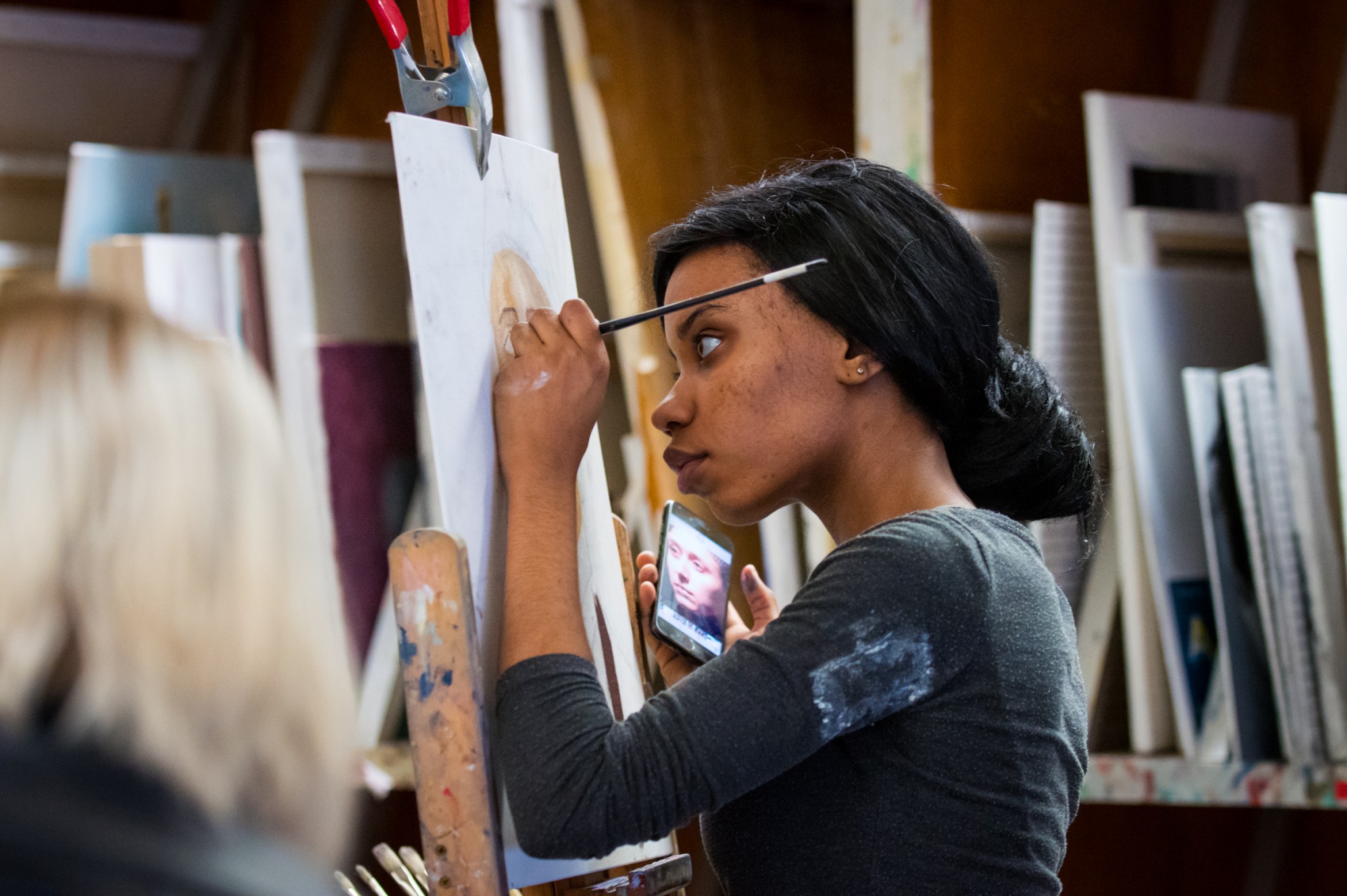 Student painting a portrait in the Art Studio