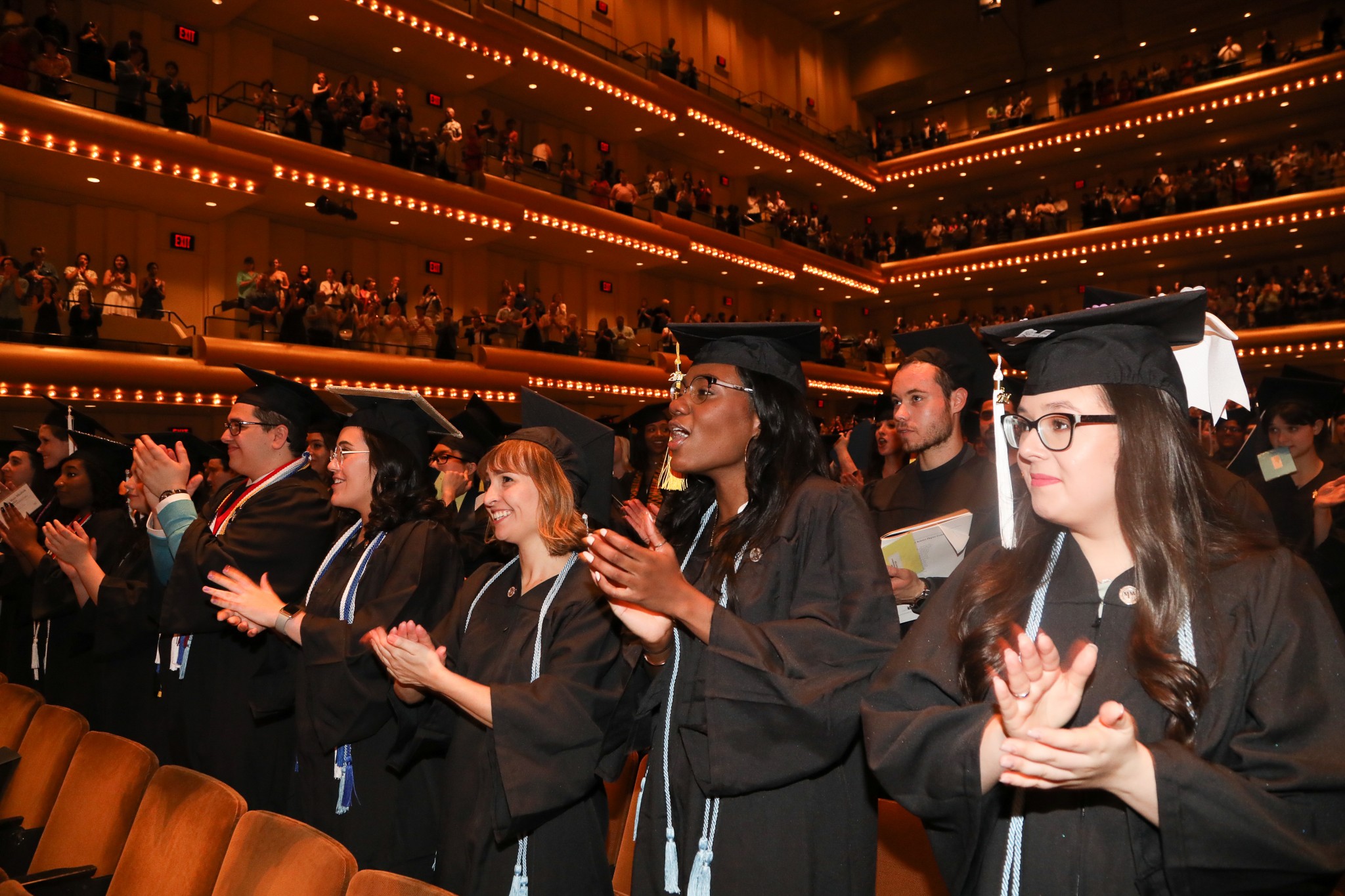 Students applauding for someone being honored at Commencement 2017