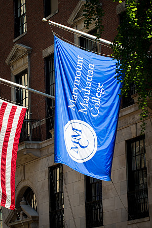 Marymount Manhattan College banner zoomed in; oriented sideways; part of the American flag is visible
