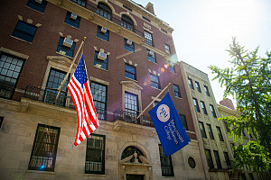 Photo of the American flag and the Marymount Manhattan College flag sticking out of Marymount Manhattan College's second floor windows