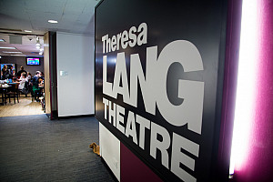 Close-up of the Theresa Lang Theatre; students in Starbucks also shown