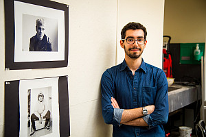Professor standing in front of artwork in the Art Studio