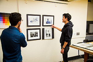 Student explaining his work to his professor in the Art Studio