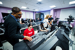 Professor helping a student on a computer in the Communication Arts Studio