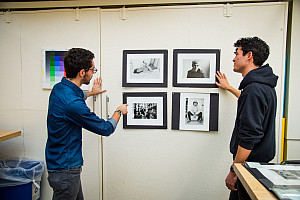 Professor and student examining artwork in the Art Studio