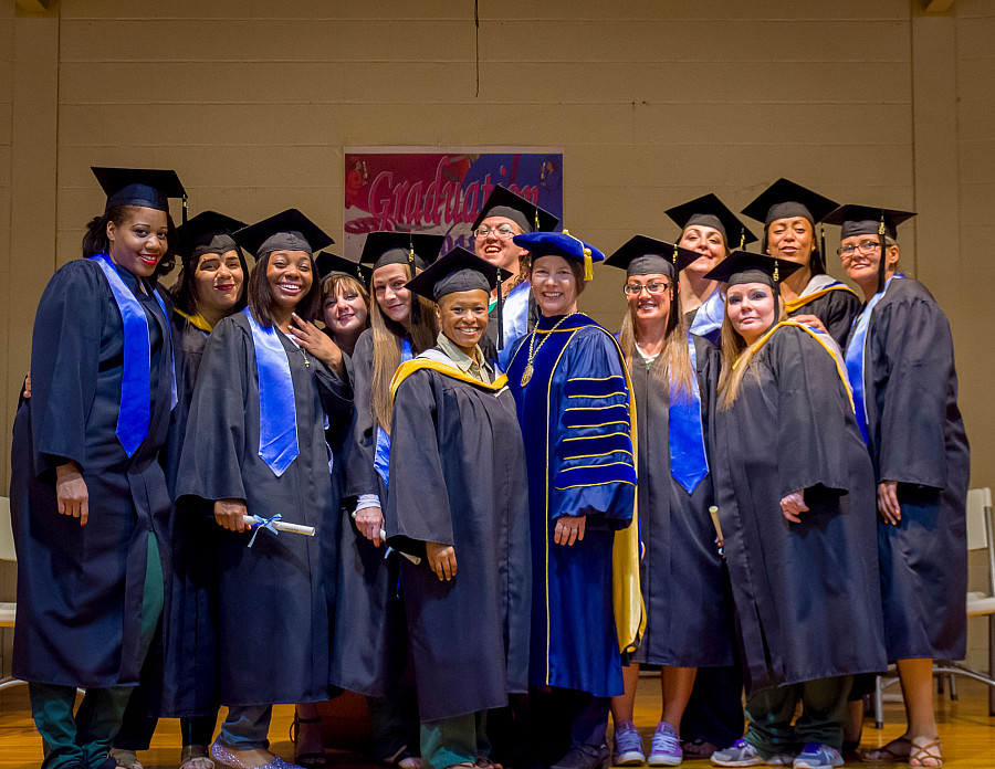 MMC President Kerry Walk (center right) with the 2018 Bedford Hills College Program graduates.