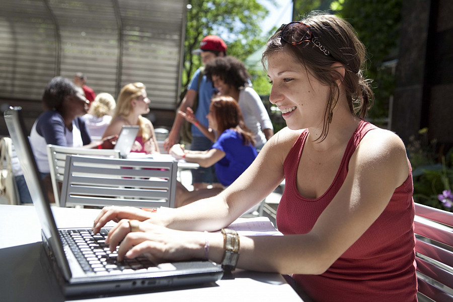 Student using laptop computer on the Lowerre Terrace