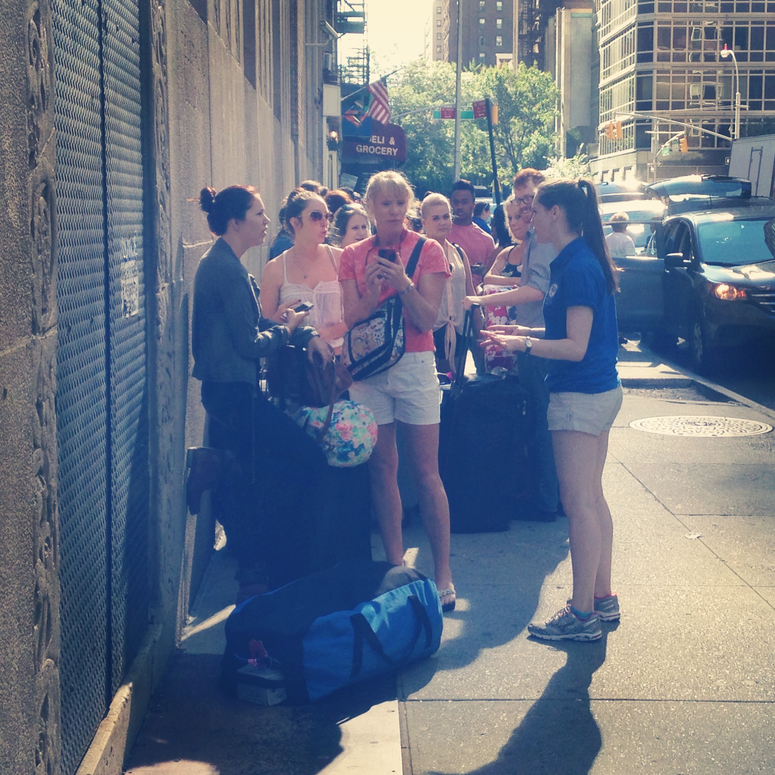 A Resident Advisor speaks with incoming students in the walk-up line at our 55th Street Residence Hall check-in. Students arriving by pub...