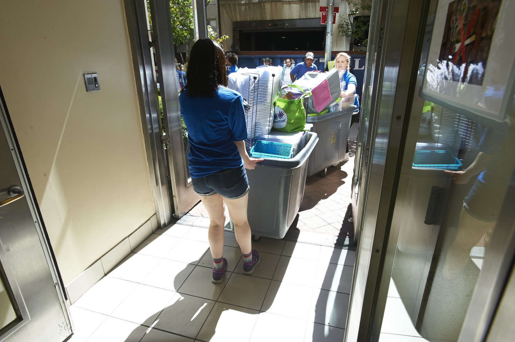 After unloading your items, resident advisors help bring your bins to your new home.