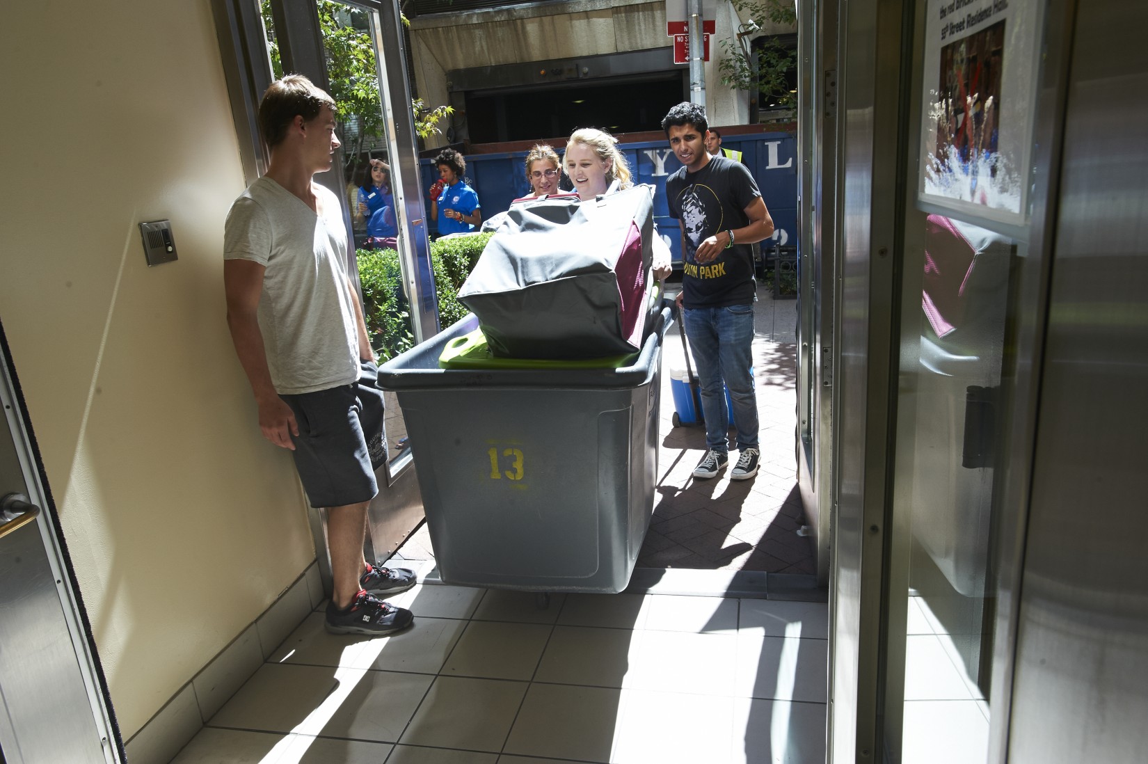 A resident advisor assists a new student at check in.