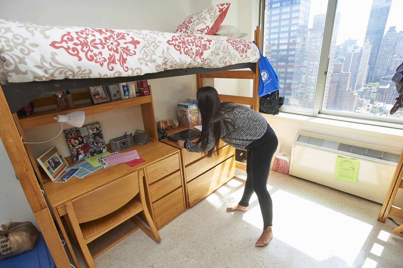 A resident sets up her room after check in.