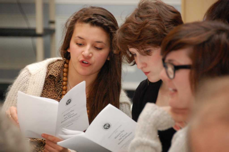 Students review the program for Honors Day