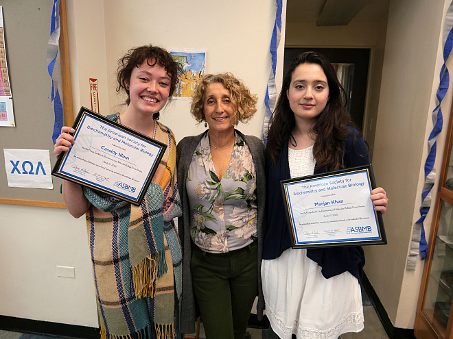 Cassandra Illum '21 and Marjan Khan '20 pose with Professor Ann Aguanno after their induction into Chi Omega Lambda.