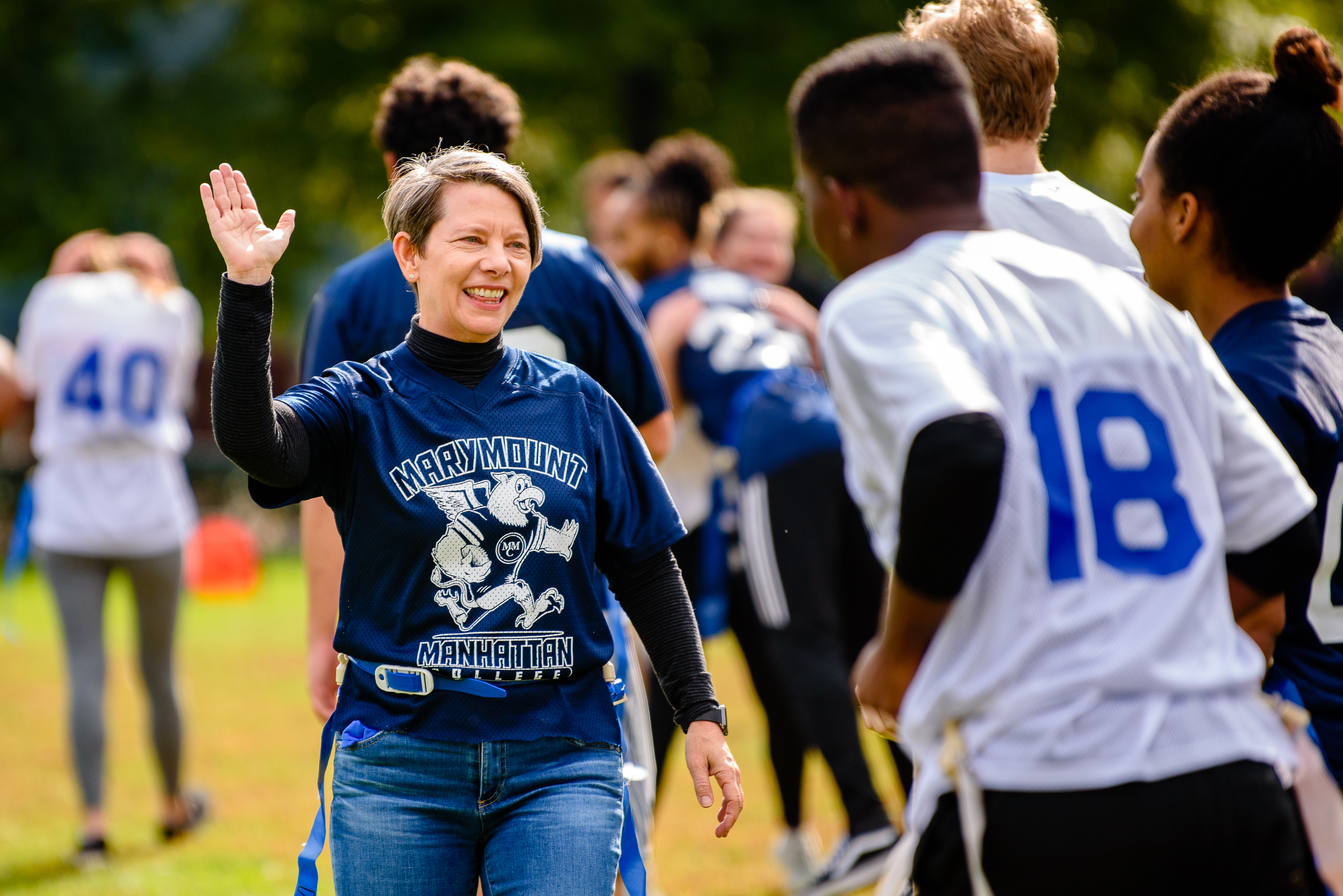 President Kerry Walk, Ph.D. high fives a student