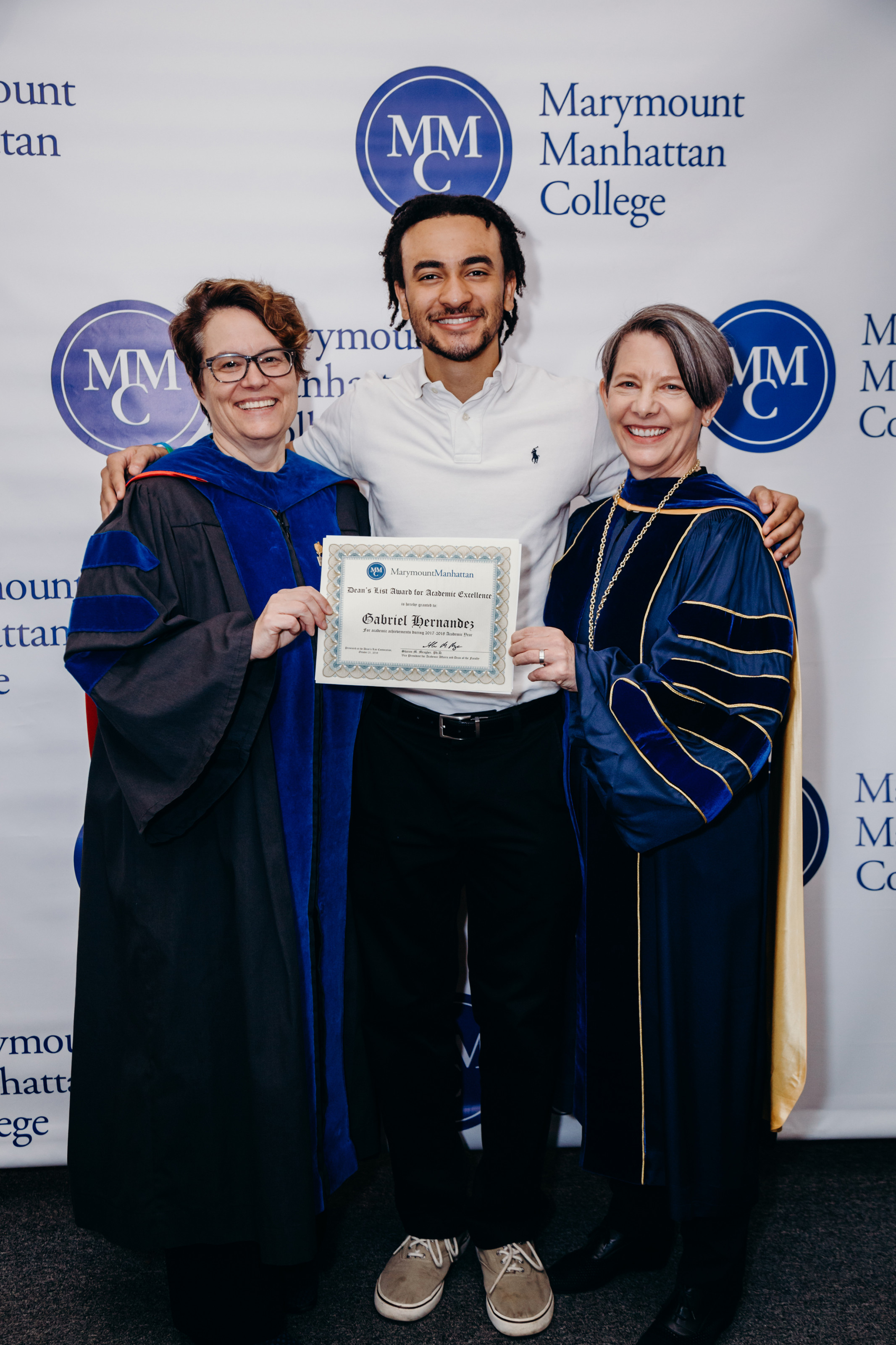 President Kerry Walk and Vice President for Academic Affairs and Dean of the Faculty pose with an MMC student