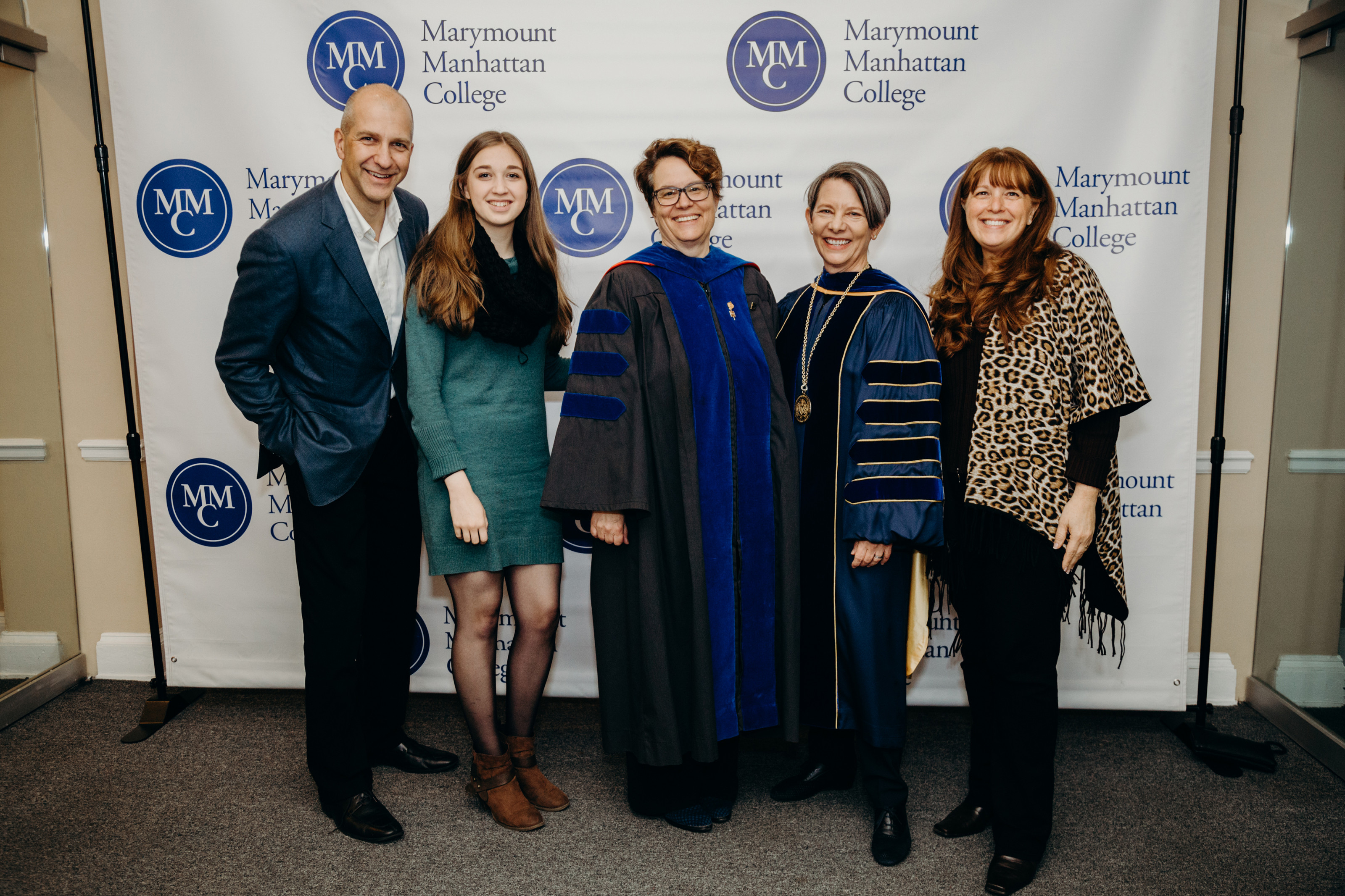 President Kerry Walk and Vice President for Academic Affairs and Dean of the Faculty pose with an MMC student and family