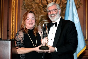 President Judson R. Shaver, Ph.D., presents Nora Moran '06 with the 75th Anniversary Gala award.