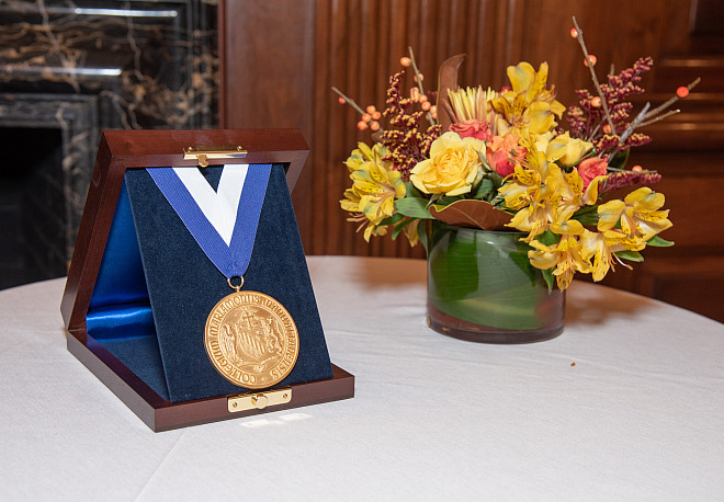 The Legacy Award Luncheon medal presented to Dean Baker