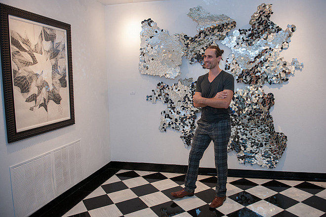 Artist Caleb Nussear with his work